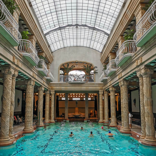 Group of people swimming in an indoor pool at Gellert spa in Bud