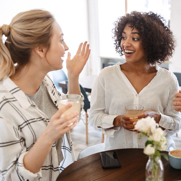 Happy young women friends having coffee break