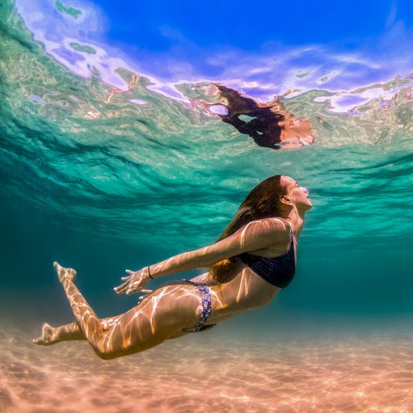 Young girl swimming in the crystal clear water, Bondi Beach, Aus